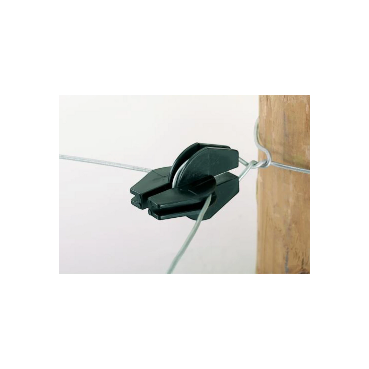 USA Grazing Systems black Double-U electric fence insulator mounted on a wooden post with wire for livestock fencing.