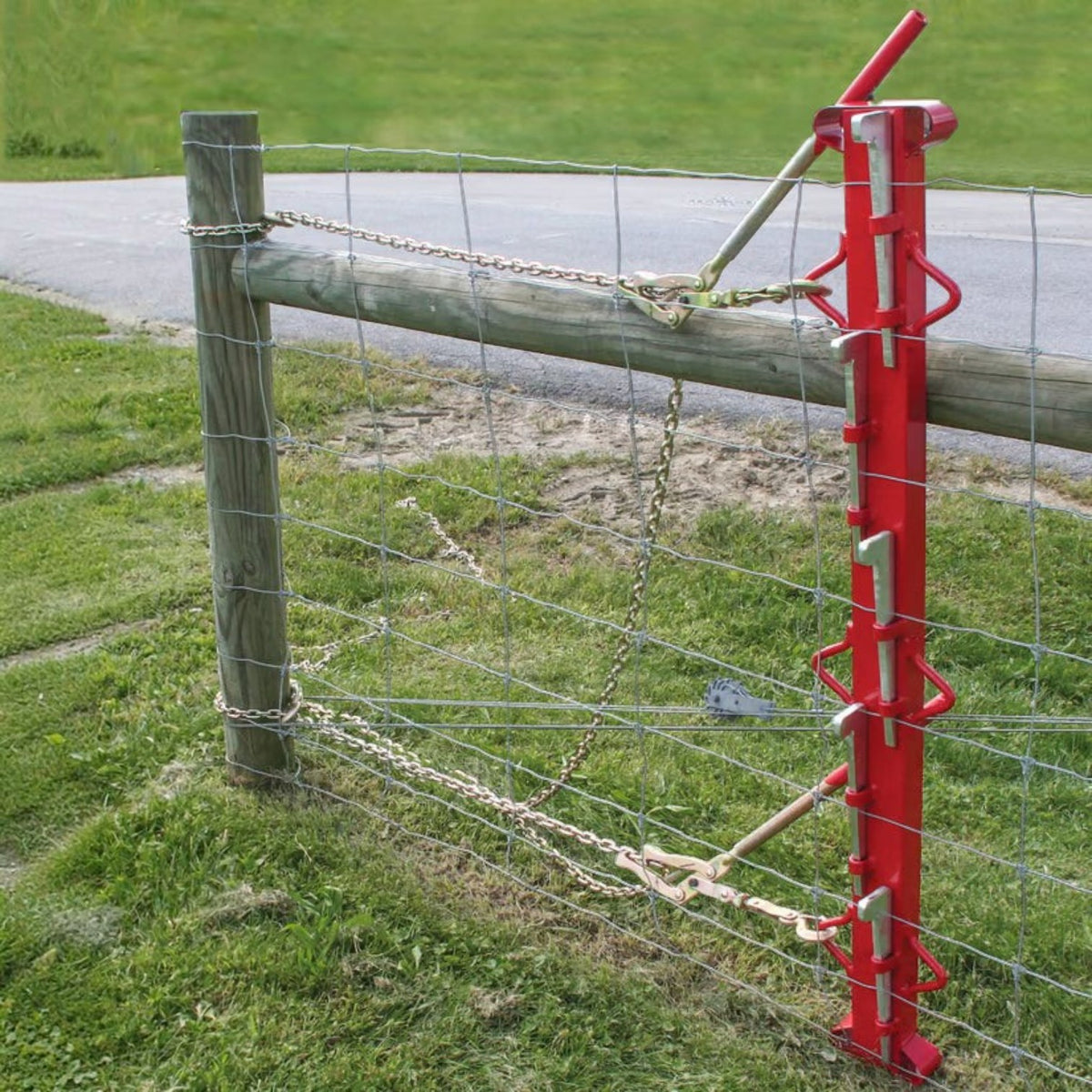 USA Grazing Systems Fencer's Choice red steel stretcher bar tensioning woven wire fencing on a wooden post