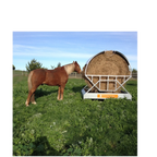 USA Grazing Systems Advantage Hay Feeder with protective roof, shielding a round hay bale from rain in a pasture.