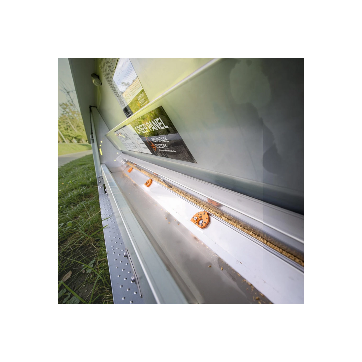 USA Grazing Systems orange cam adjusters installed on an Advantage grain feeder for precise feed control.