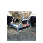 USA Grazing Systems Advantage Tray Hay Feeder with cattle eating from a round bale in a pasture.
