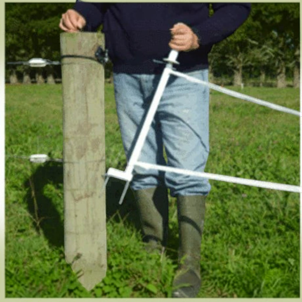 USA Grazing Systems Taragate multi-strand electric fence gate being operated by a farmer in a pasture
